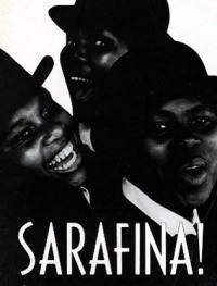 Black & white photo of 3 Black women smiling in friendship